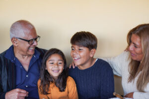 happy grandparents having fun with grandchildren at house patio
