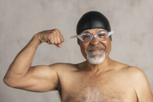 senior african american swimmer wearing a swim cap and goggles
